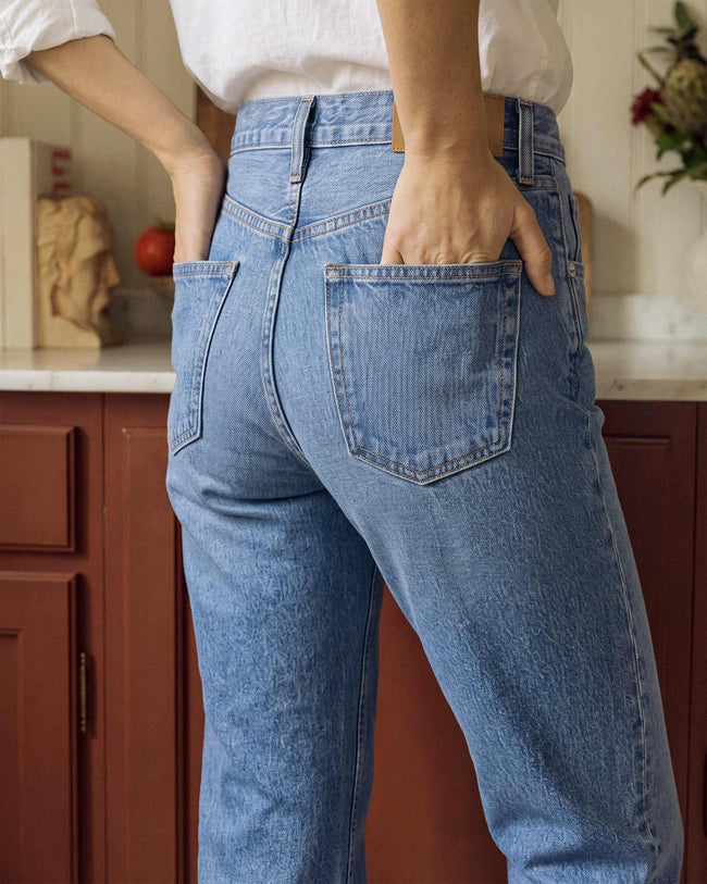 Light blue jeans close-up with front pocket and belt-loop waistband