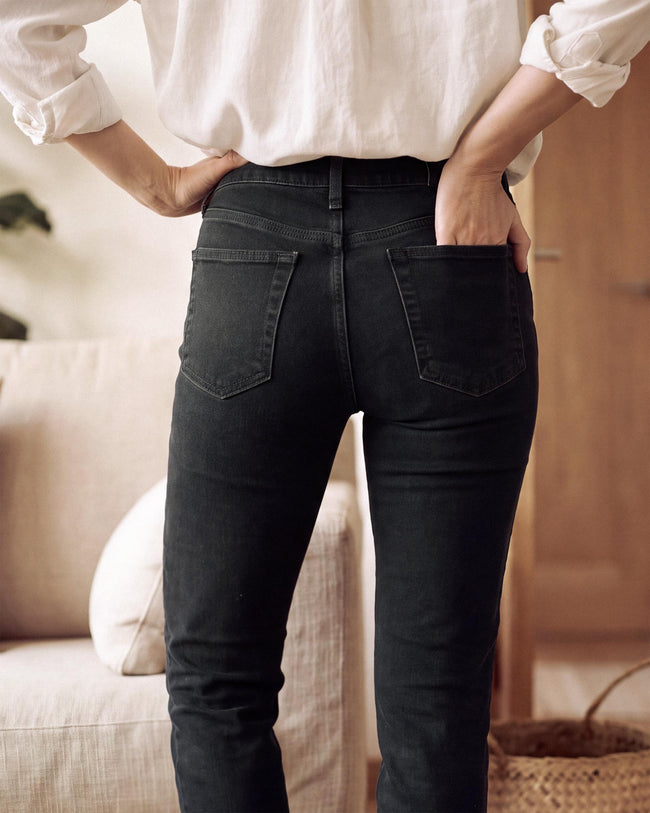 High-rise black straight jeans with front pockets and belt loops.