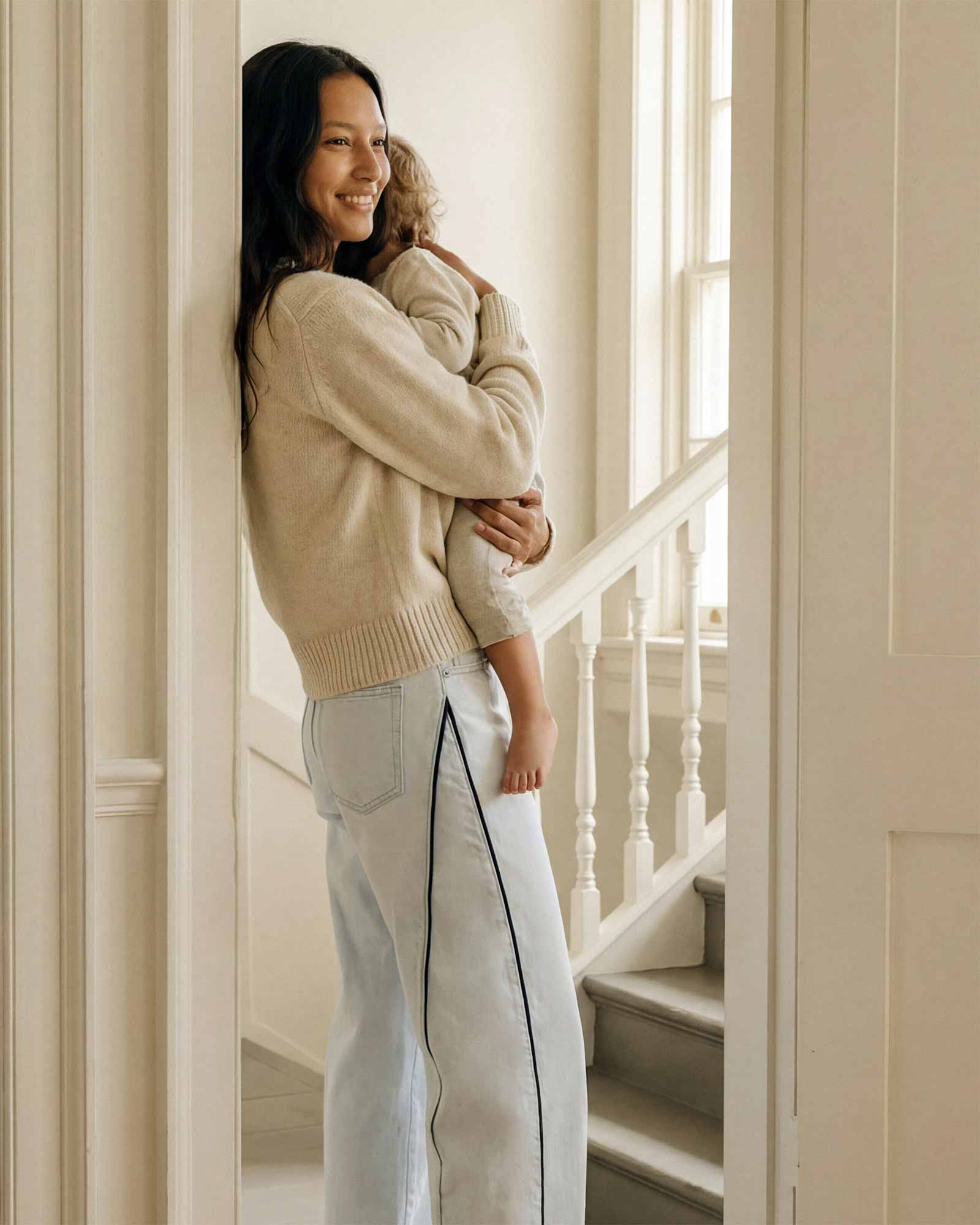 A structural detail at the outseam. The piping is precise in person and visible from a distance. A finish built into the construction, not applied over it.