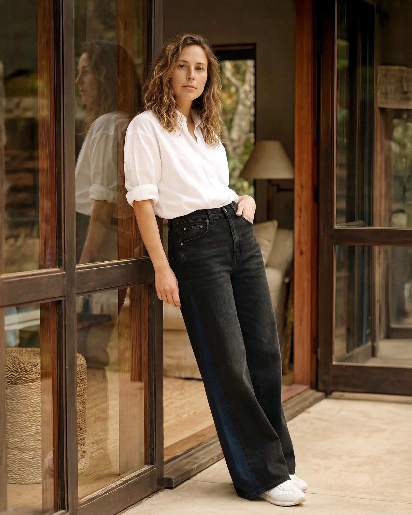 A design detail built into the construction. The dark indigo side panels run the full length of the outseam, giving the silhouette a defined edge from the front and the back.