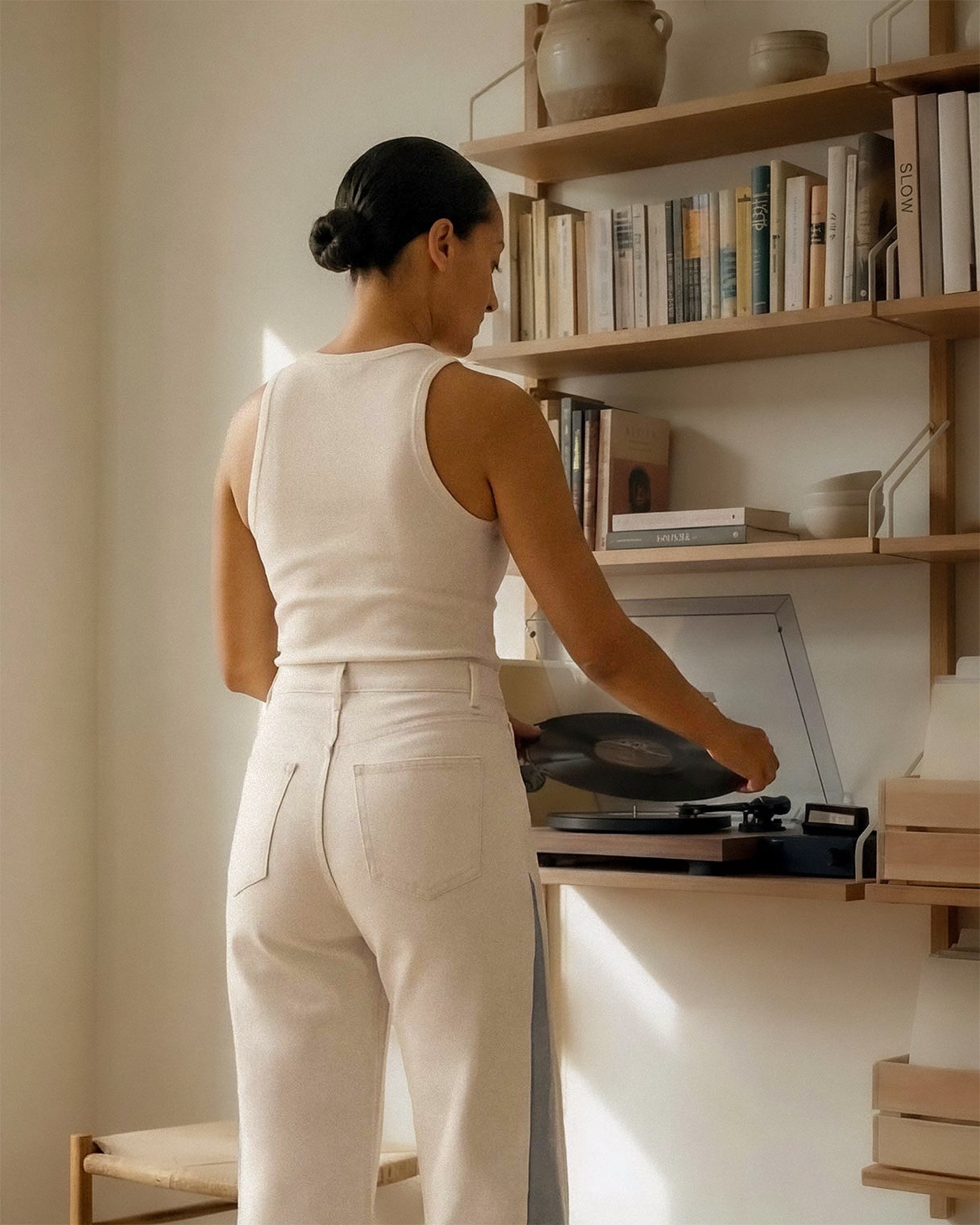 White body with light indigo panel inserts at the outseam. The contrast is clearest in natural outdoor light, where the difference between the two fabrics is most visible.