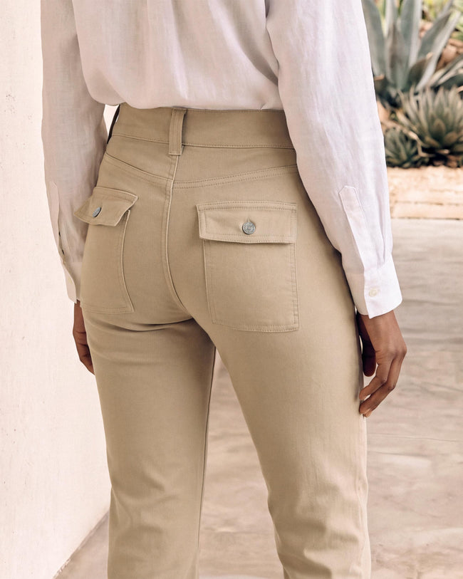 Beige cargo pants close-up with flap pocket and metal button