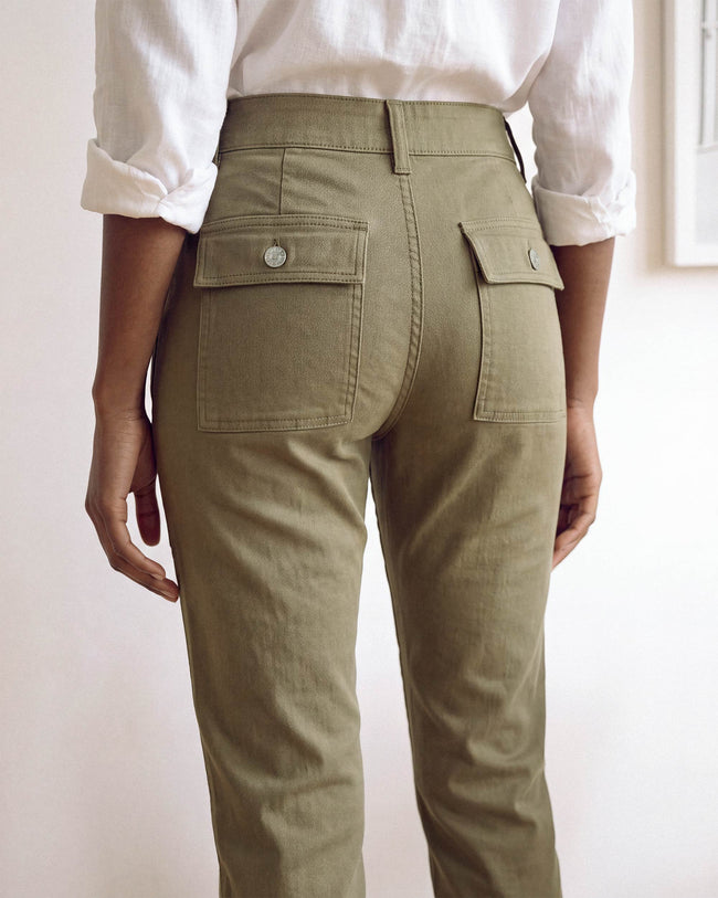 Olive cargo pants close-up: waistband, zip fly, and front flap pockets
