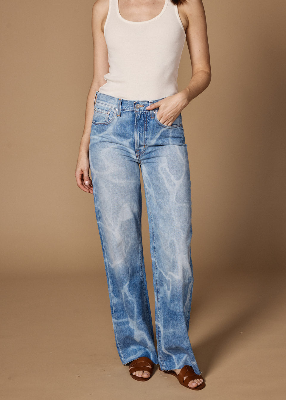 Elevate your style with the Marli Wide Leg in Pool Laser. This high-rise, wide-leg design flatters your waist and hips, perfect for making a bold statement.