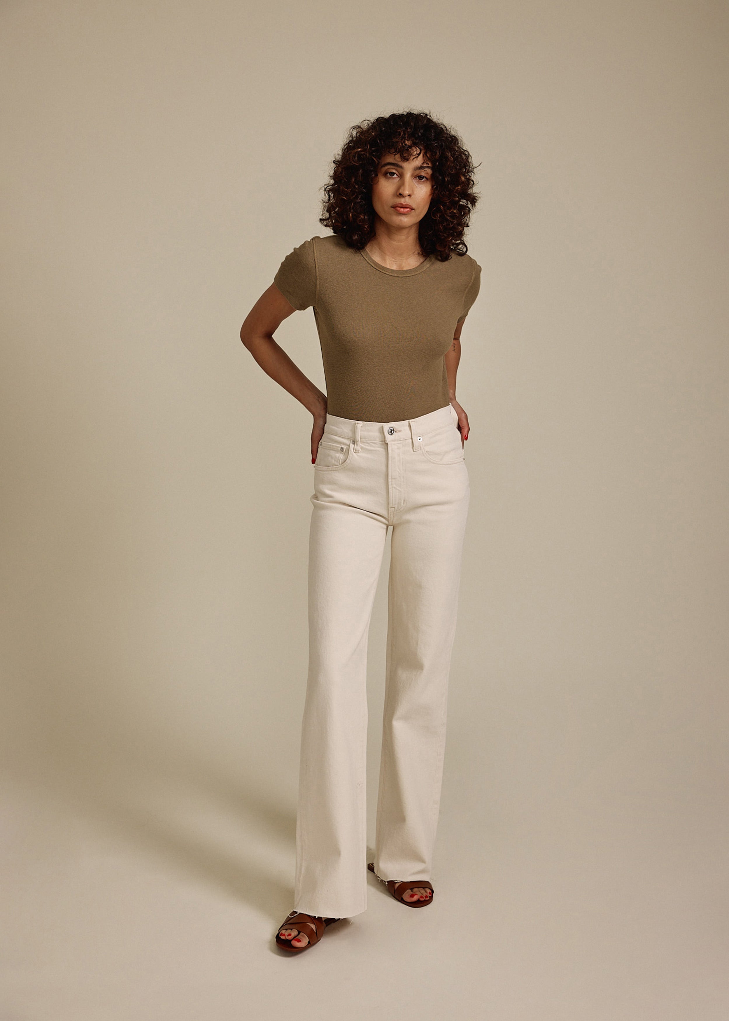 Elevate your style with the Marli Wide Leg jeans in Parchment. Featuring a high rise and chic raw hem, these jeans offer a flattering fit and effortless elegance.